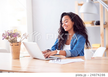 Positive woman sitting at the table 24874286