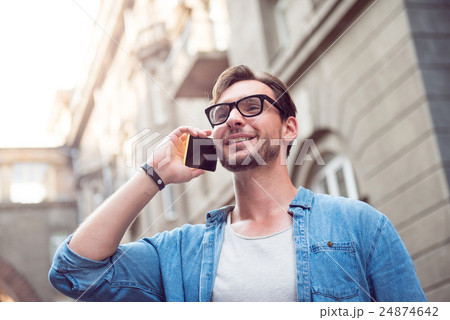 Joyful attractive man speaking on the phone 24874642