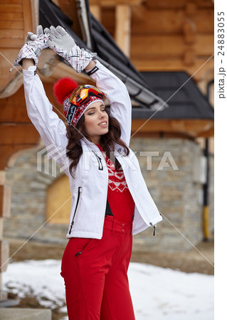 Woman skier in wooden home terrace Woman skier in wooden home terrace 24883055