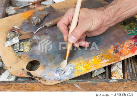 male hand holding paint brush 24886819