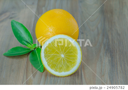 ripe orange with leaves on wooden background ripe orange with leaves on wooden background 24905782