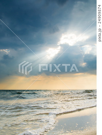 Sun rays breaking through the clouds at sunset 24909874