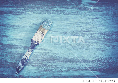Vintage toned dirty paintbrush with blue paint. 24913993