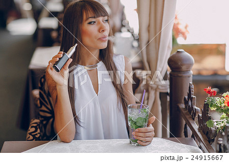 girn in cafe with E-Cigarette 24915667