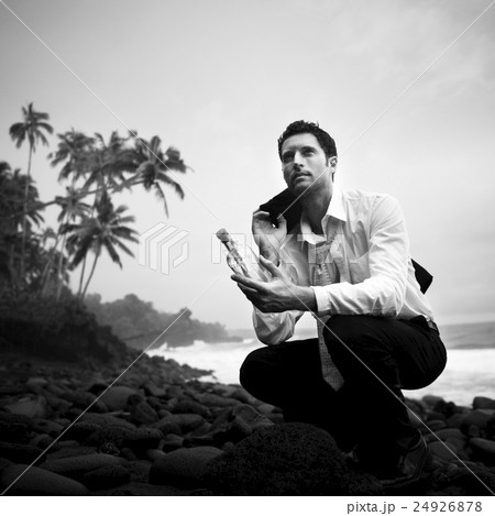 Businessman with Message in a Bottle Concept Businessman with Message in a Bottle Concept 24926878