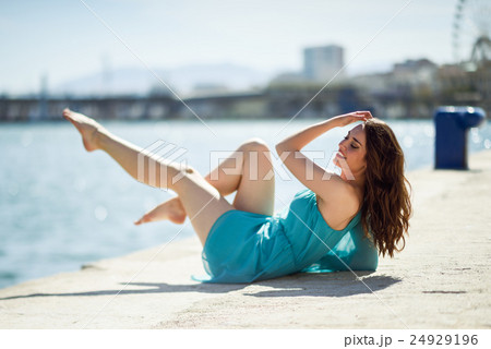 Woman with blue eyes wearing blue dress in the beach. 24929196