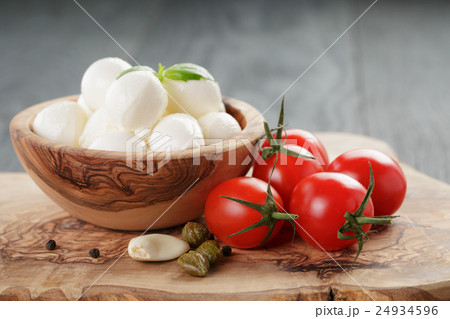 small balls of mozzarella with basil leaves small balls of mozzarella with basil leaves 24934596