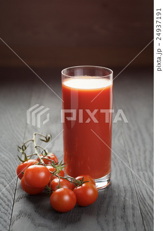 glass of tomato juice on wooden table glass of tomato juice on wooden table 24937191