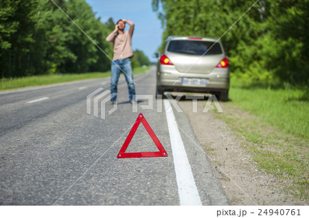 Expressive man talking on the phone after accident Expressive man talking on the phone after accident 24940761