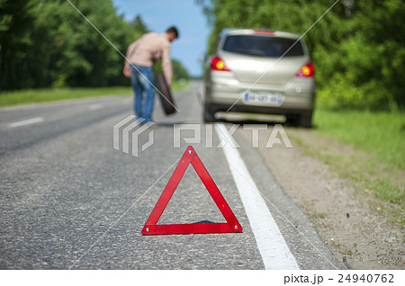 Male driver with spare wheel after breakdown 24940762