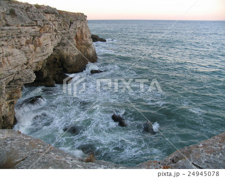 Sea coast in winter with clouds and waves Sea coast in winter with clouds and waves 24945078