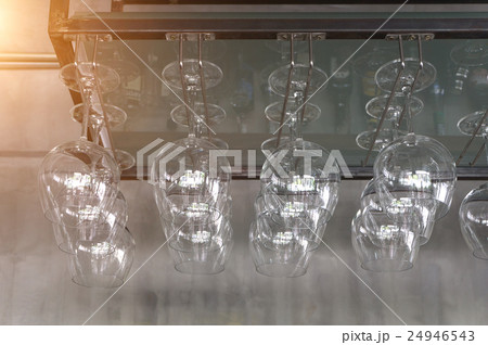 Wine glasses hanging in the wine shop. 24946543