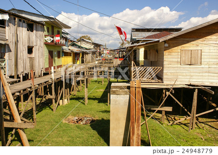 Houses on stilts rise above the polluted water Houses on stilts rise above the polluted water 24948779
