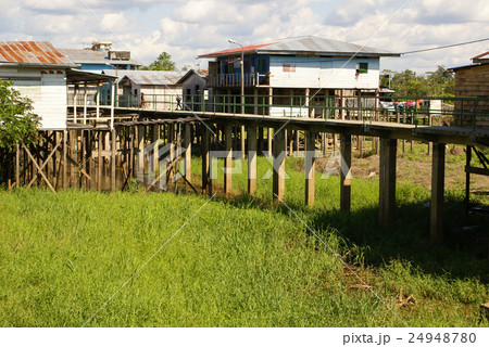 Houses on stilts rise above the polluted water  24948780
