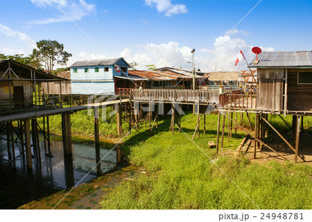 Houses on stilts rise above the polluted water Houses on stilts rise above the polluted water 24948781