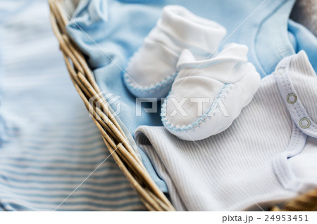 close up of baby clothes for newborn boy in basket close up of baby clothes for newborn boy in basket 24953451