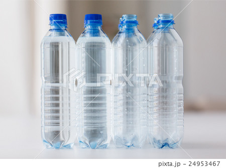 close up of bottles with drinking water on table 24953467
