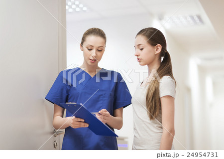 doctor or nurse with clipboard and girl patient 24954731