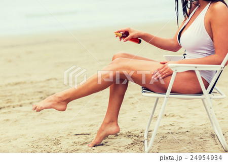 close up of woman sunbathing on beach close up of woman sunbathing on beach 24954934