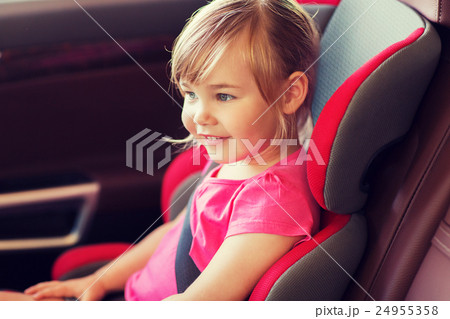 happy little girl sitting in baby car seat happy little girl sitting in baby car seat 24955358