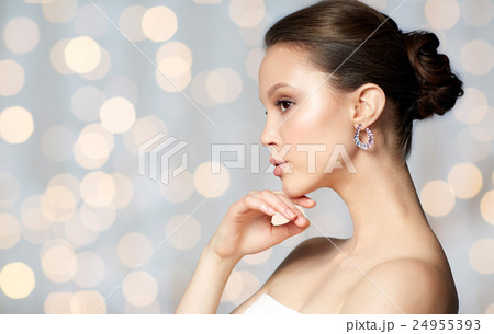 close up of beautiful woman face with earring close up of beautiful woman face with earring 24955393