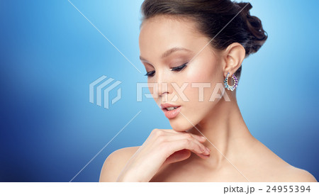 close up of beautiful woman face with earring close up of beautiful woman face with earring 24955394