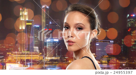 beautiful young asian woman over black background 24955397