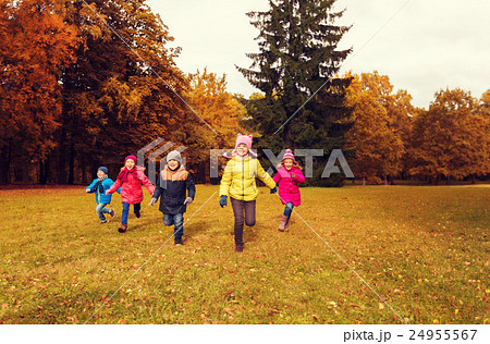 group of happy little kids running outdoors group of happy little kids running outdoors 24955567