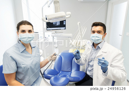 close up of dentist and assistant at dental clinic 24956126