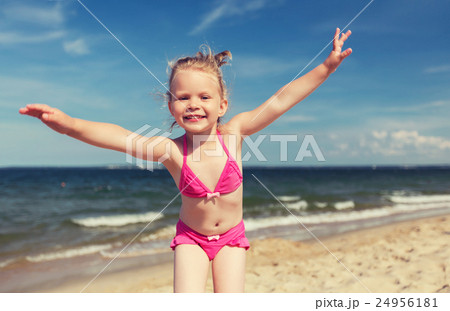 happy little girl in swimwear having fun on beach happy little girl in swimwear having fun on beach 24956181