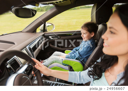 happy woman with little girl driving in car 24956607