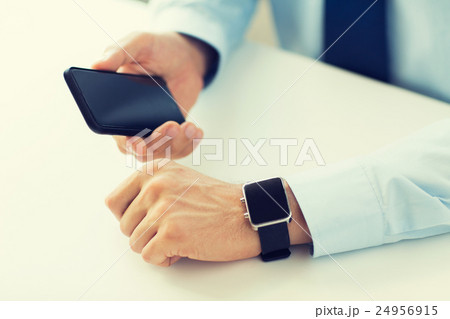 close up of hands with smart phone and watch close up of hands with smart phone and watch 24956915