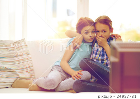 scared little girls watching horror on tv at home scared little girls watching horror on tv at home 24957731