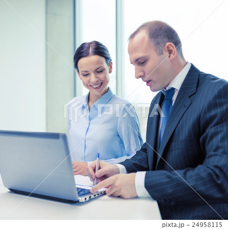 business team with laptop having discussion 24958115