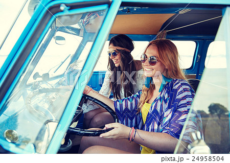 smiling young hippie women driving minivan car 24958504