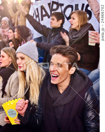 Sport fans holding champion banner on tribunes. 24966702