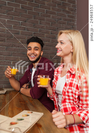 Mix Race Man And Woman Hold Glasses With Orange 24968557