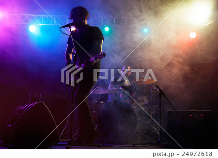 Silhouette of guitar player on stage. Silhouette of guitar player on stage. 24972618