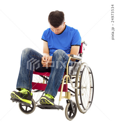 frustrated handicapped man sitting on a wheelchair frustrated handicapped man sitting on a wheelchair 24973534