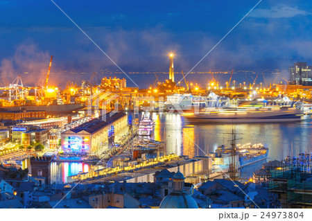 Old Lighthouse in port of Genoa at night, Italy. 24973804