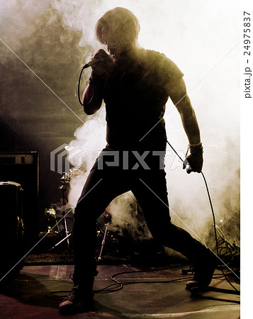 Rock band performs on stage. Singer. Rock band performs on stage. Singer. 24975837