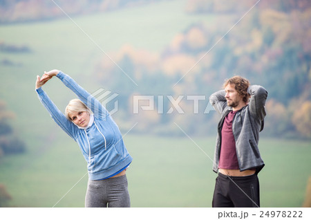 Two young beautiful runners in autumn nature 24978222