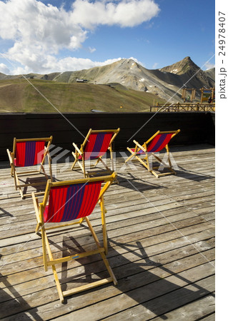 Deckchairs on terrace with Italian Alps mountains Deckchairs on terrace with Italian Alps mountains 24978407