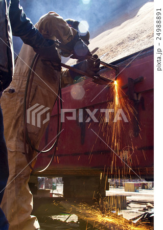 Man welding wearing protective clothes and equipme Man welding wearing protective clothes and equipme 24988891