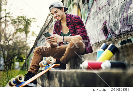 Teenager Boy Texting Skateboard Concept 24989892