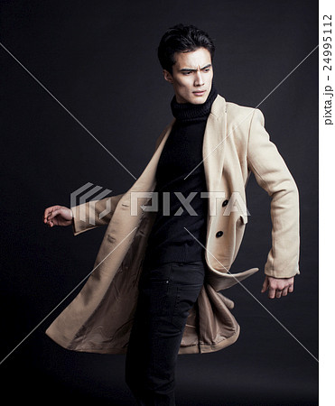 cool real young man in coat on black background cool real young man in coat on black background 24995112