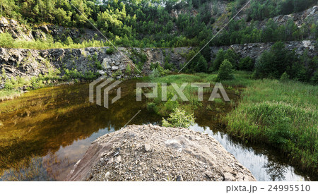 abandoned flooded quarry, Czech republic abandoned flooded quarry, Czech republic 24995510