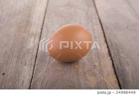 fresh raw egg on wooden table 24996449