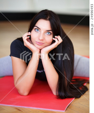 cute brunette in the gym doing exercises, looking cute brunette in the gym doing exercises, looking 24996493