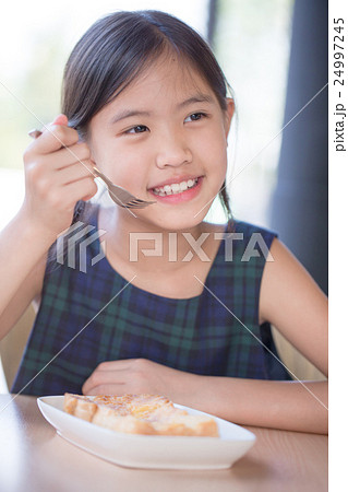 Asian girl enjoy eating Banana split ice-cream Asian girl enjoy eating Banana split ice-cream 24997245